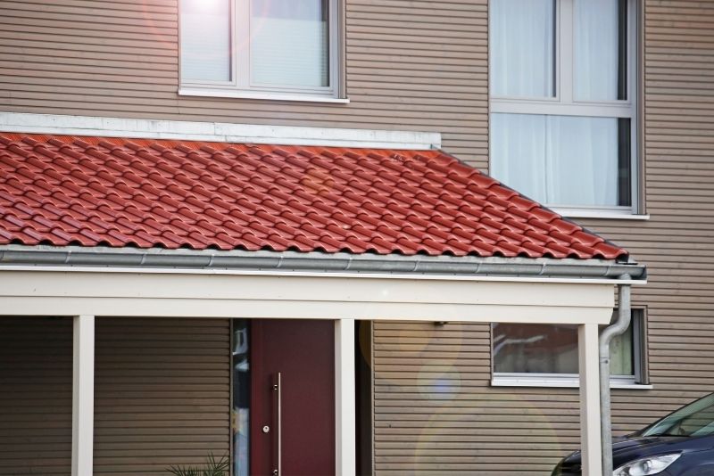 An attached carport with sloping roof